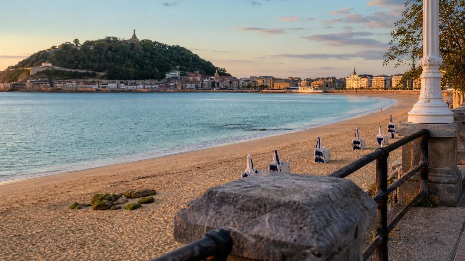 Curved sandy bay in San Sebastian at early evening