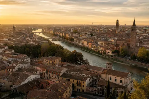 Golden-hour view over a European old town's rooftops and river